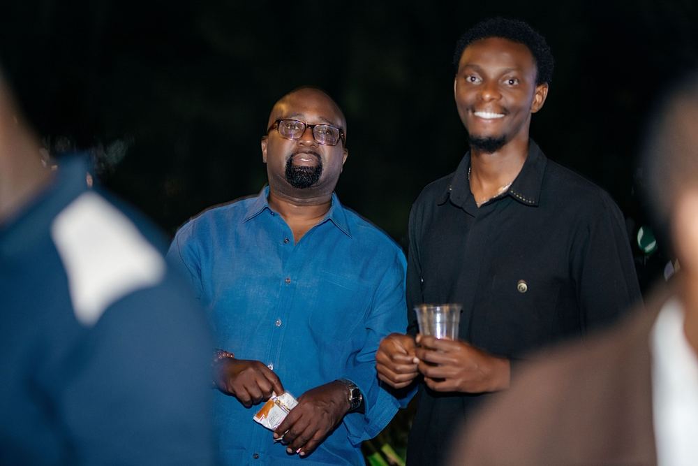 Two guests smile and listen during the evening